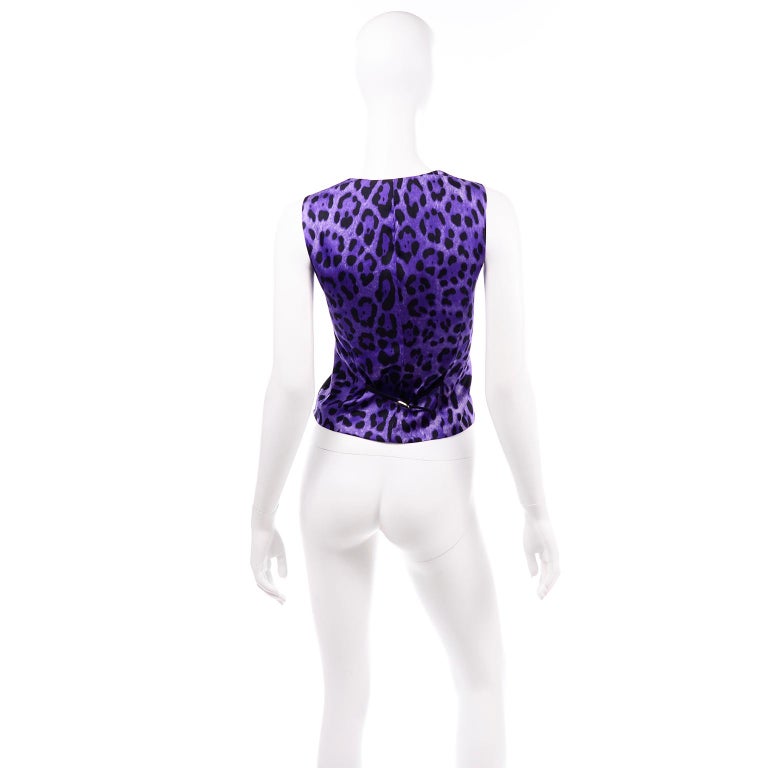 This Dolce & Gabbana vest is unworn and still has its original tags attached! We love the purple leopard printed back and inside lining. The front of the vest is black wool and there are two front pockets that are still sewn closed. There are