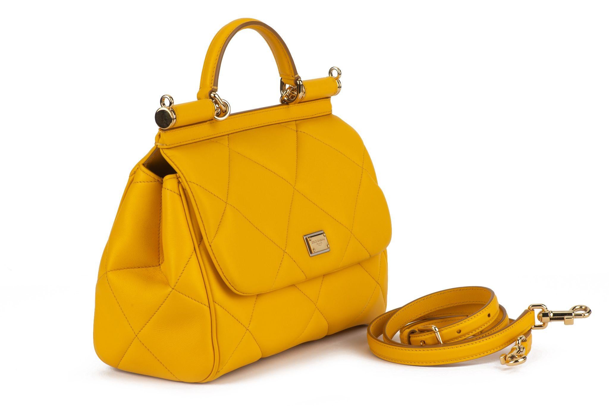 Dolce and Gabbana Sicily Handbag in yellow soleil quilted Aria Calfskin makes your look go from day to night in this casual sleek handbag. Featuring yellow calfskin leather, a  front flap with hidden double magnetic fastening, logo tag featuring two