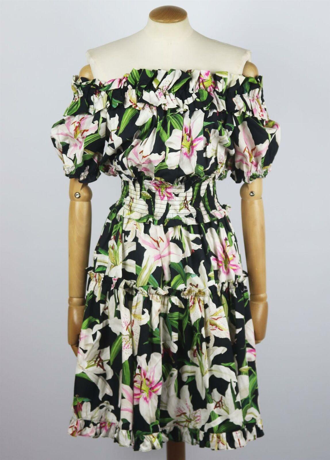 This Dolce & Gabbana dress is cut from naturally light and airy cotton-poplin printed with painterly lilies and trimmed with ruffles from shoulder to hem, the neckline is elasticated to ensure it stays in place, while the waist is shirred to