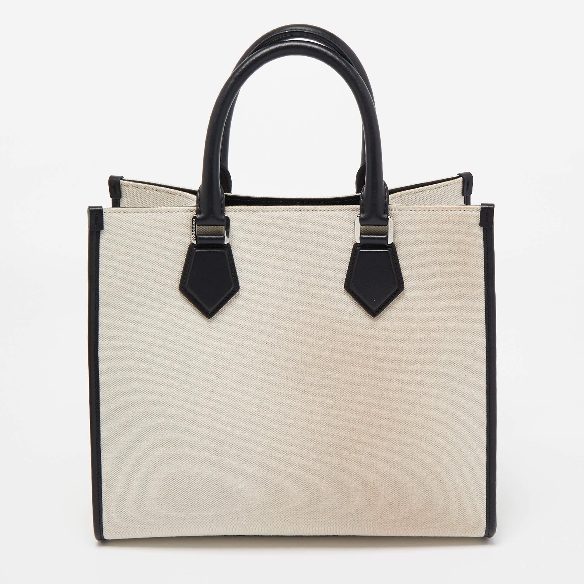 Do you know what would be the perfect bag to swing for your daily errands or sprees? This one here from Dolce & Gabbana. It is perfect! Crafted from off-white and black leather, the bag has a lovely shape, two leather handles, and a spacious