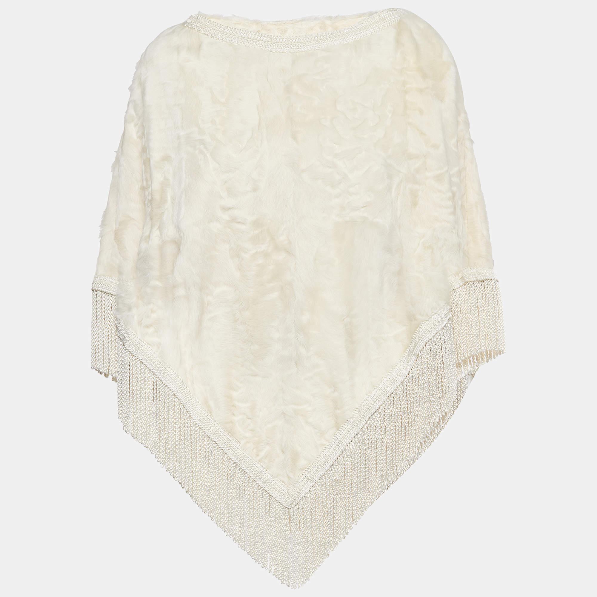 Embrace luxurious warmth with the Dolce & Gabbana poncho. Crafted with sumptuously soft shearling, its off-white hue exudes timeless elegance. Tassel detailing adds a playful touch, making it a chic yet cozy addition to any winter ensemble, perfect