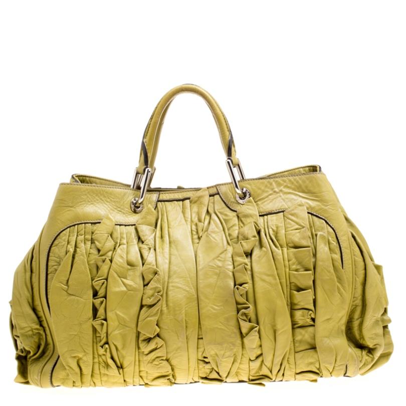 This Dolce & Gabbana bag is durable and handy. It is crafted from olive green leather and designed with two handles and a spacious fabric interior. Comfort and style go hand in hand with this smart and stylish leather accessory.

Includes: The
