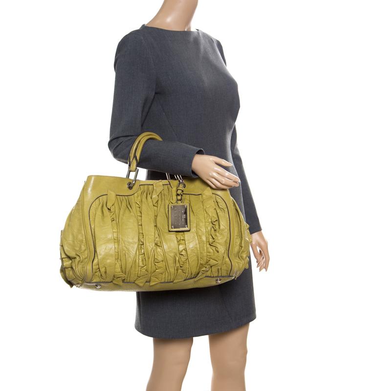 This Dolce & Gabbana bag is durable and handy. It is crafted from olive green leather and designed with two handles and a spacious fabric interior. Comfort and style go hand in hand with this smart and stylish leather accessory.

