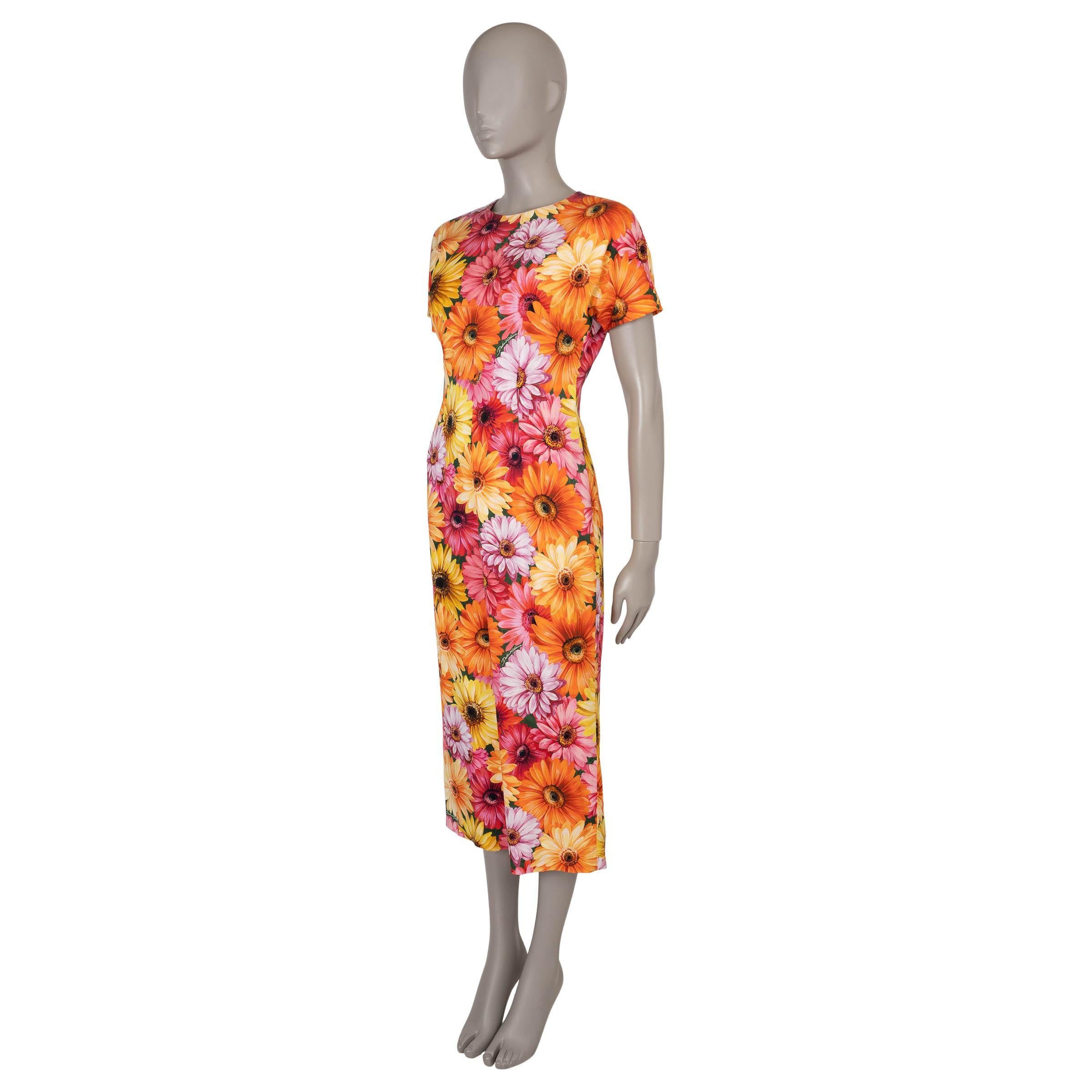 This 100% authentic Dolce & Gabbana dress in yellow, orange, and pink Daisy-printed charmeuse silk (with 11% elastane) radiates vibrant femininity. Designed with a fitted midi-length silhouette, it features a classic crewneck and short sleeves for