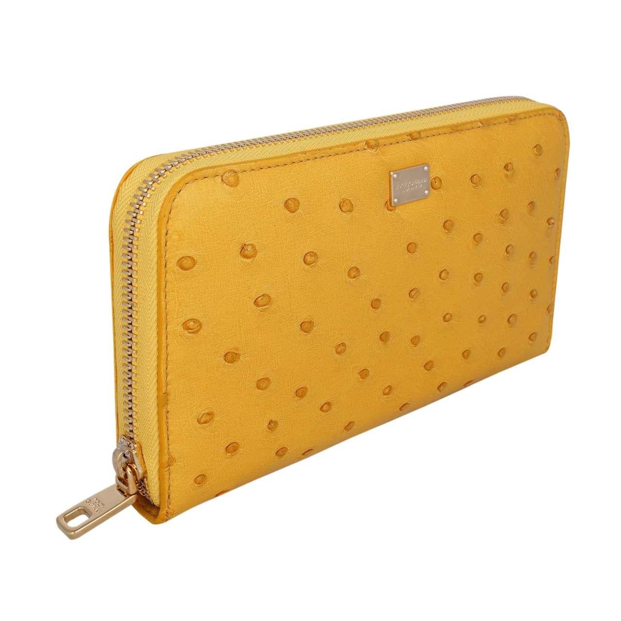 - Ostrich Leather Zip-Around wallet with logo plate in yellow by DOLCE & GABBANA - New with Tag - MADE IN ITALY - Former RRP: EUR 995 - Model: BI0473-B8285-80220 - Material: 100% Ostrich - Metal logo plate in front - 3 dividers, 2 bills pockets,
