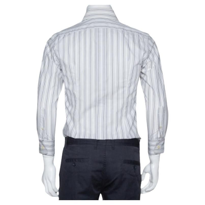 Perfect office wear, this shirt by Dolce & Gabbana is a power statement. It has been crafted from cotton. It comes in a pale grey color and carries a striped exterior. It has long sleeves, button front, a simple collar, and is tailored to offer a