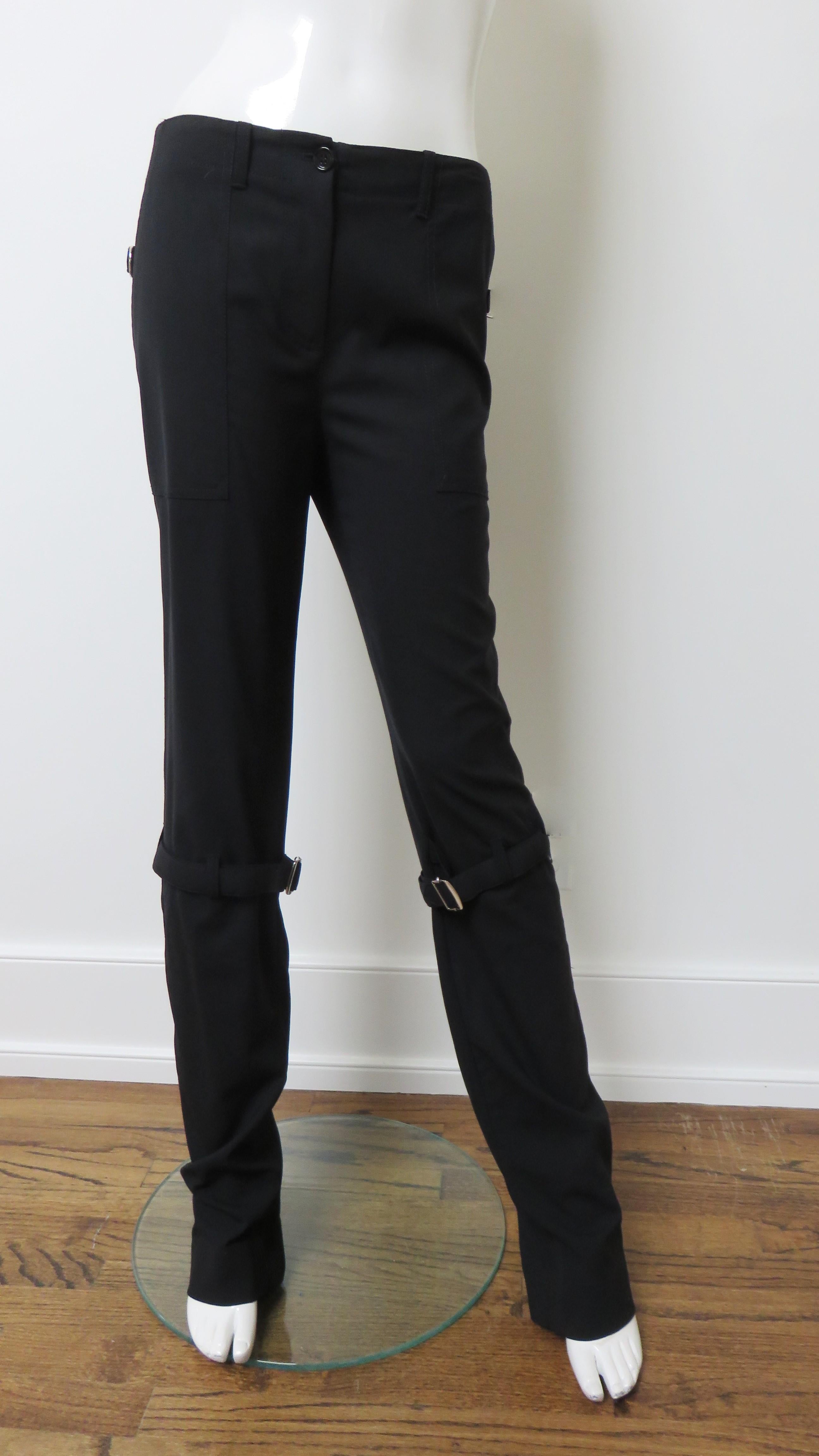 Fabulous black light weight wool pants with a bit of stretch by Dolce & Gabbana. They are mid rise with hip pockets and straight legs with an adjustable buckle strap around each at knee level and 2 vertical functional back separating zippers along