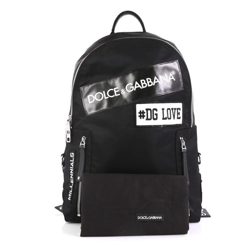 This Dolce & Gabbana Patches Backpack Nylon with Applique, crafted from black nylon, features adjustable shoulder straps, exterior zip pockets, label patches and applique, and silver-tone hardware. Its zip closure opens to a burgundy nylon interior.