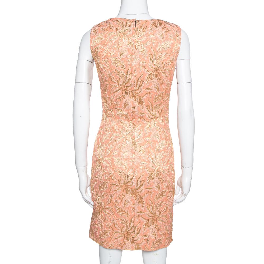 This dress exudes Dolce & Gabbana's classic and feminine roots. It features a floral brocade design, is sleeveless, and comes with a back zip closure. This peach silk creation is perfect for a formal lunch or dinner.

