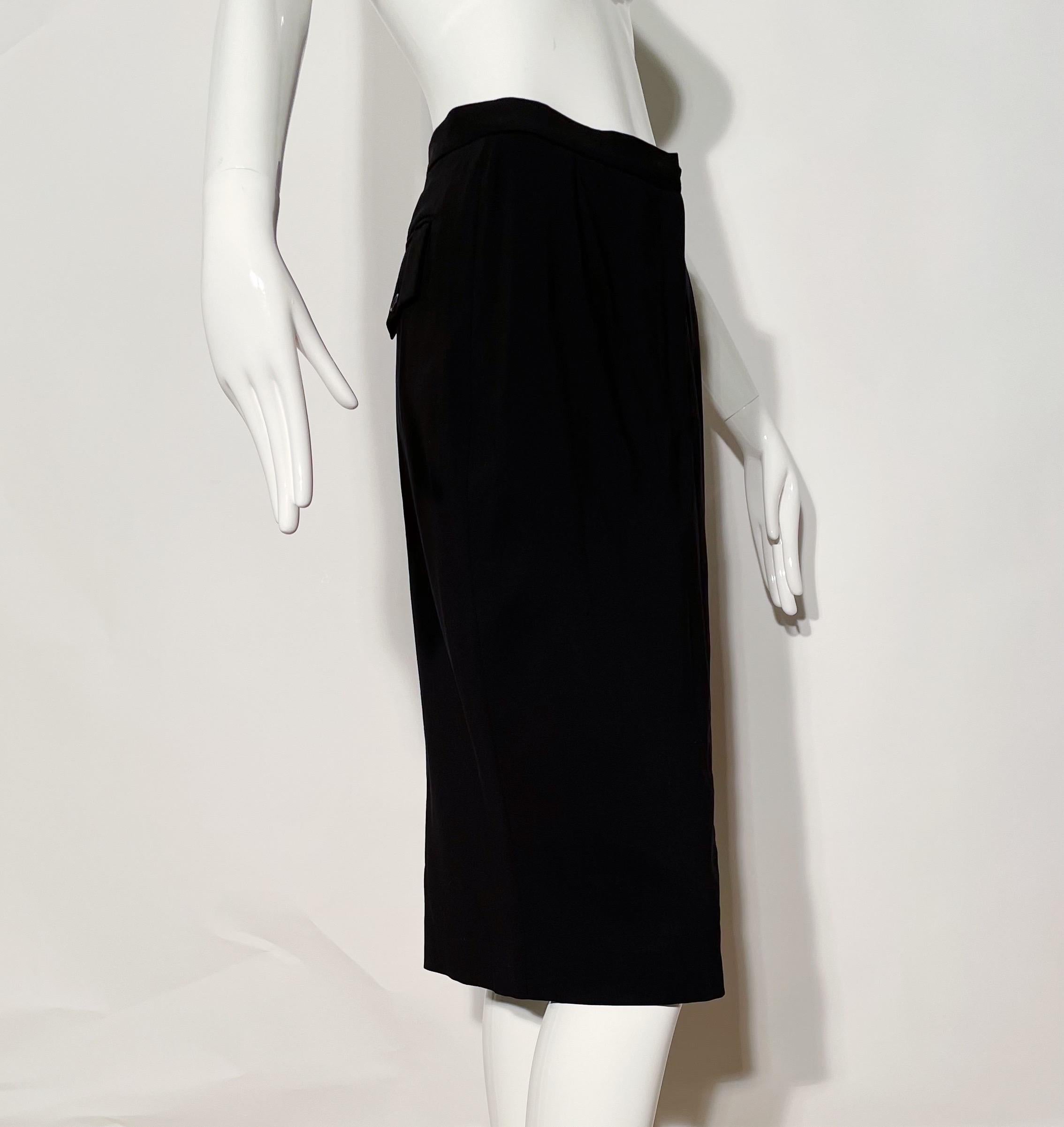 Black pencil skirt. Front clasp closure. Rear back pockets. Wool and nylon blend. Made in Italy. 
*Condition: Excellent vintage condition. No visible flaws.

Measurements Taken Laying Flat (inches)—
Waist: 26 in.
Hip: 34 in.
Length: 27 in.
Marked