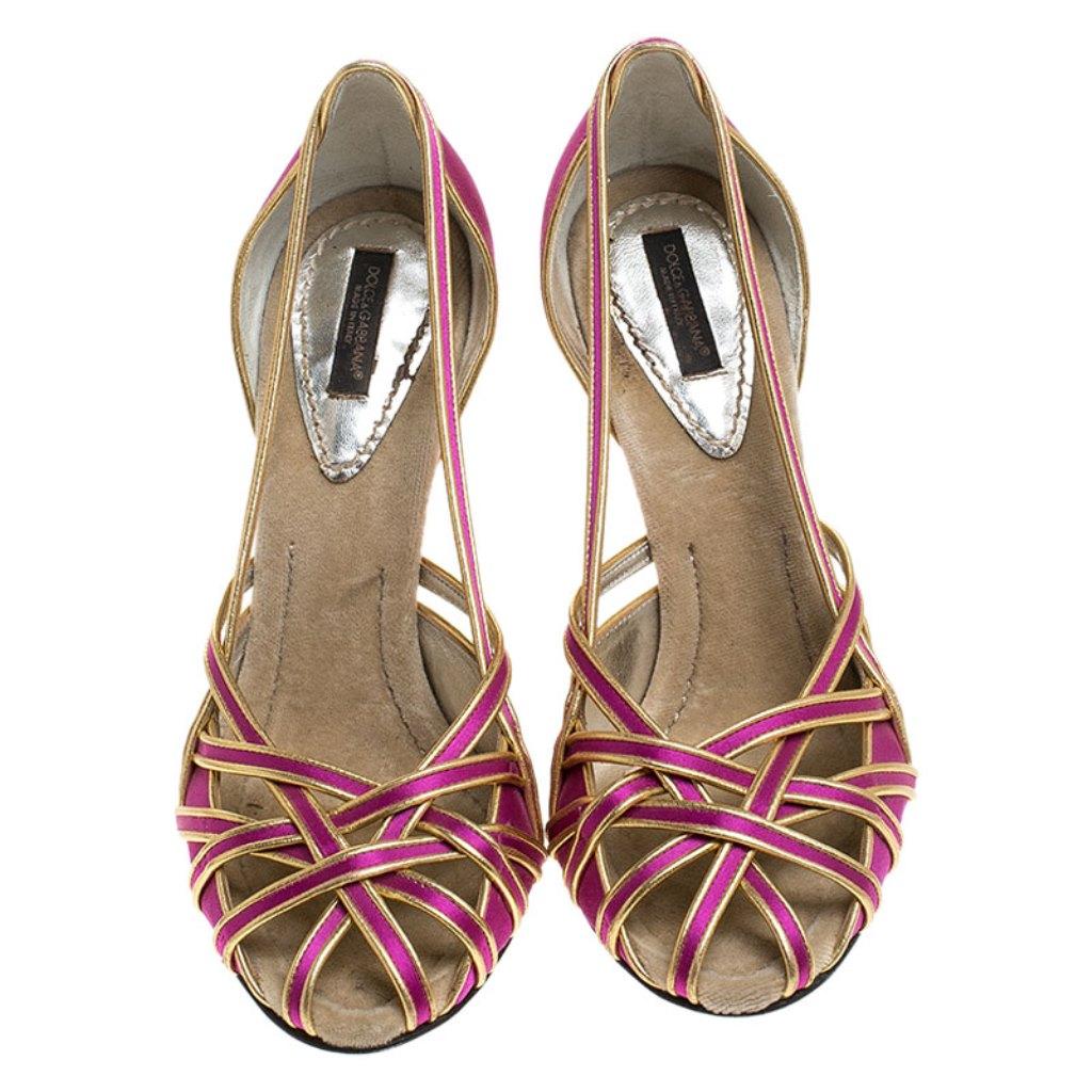 Dolce & Gabbana's designs come with a style that leaves all in awe. Take a look at these pumps! They've been crafted from satin in a strappy layout and styled in a wonderful combination of pink and gold hues. The pair is complete with snug