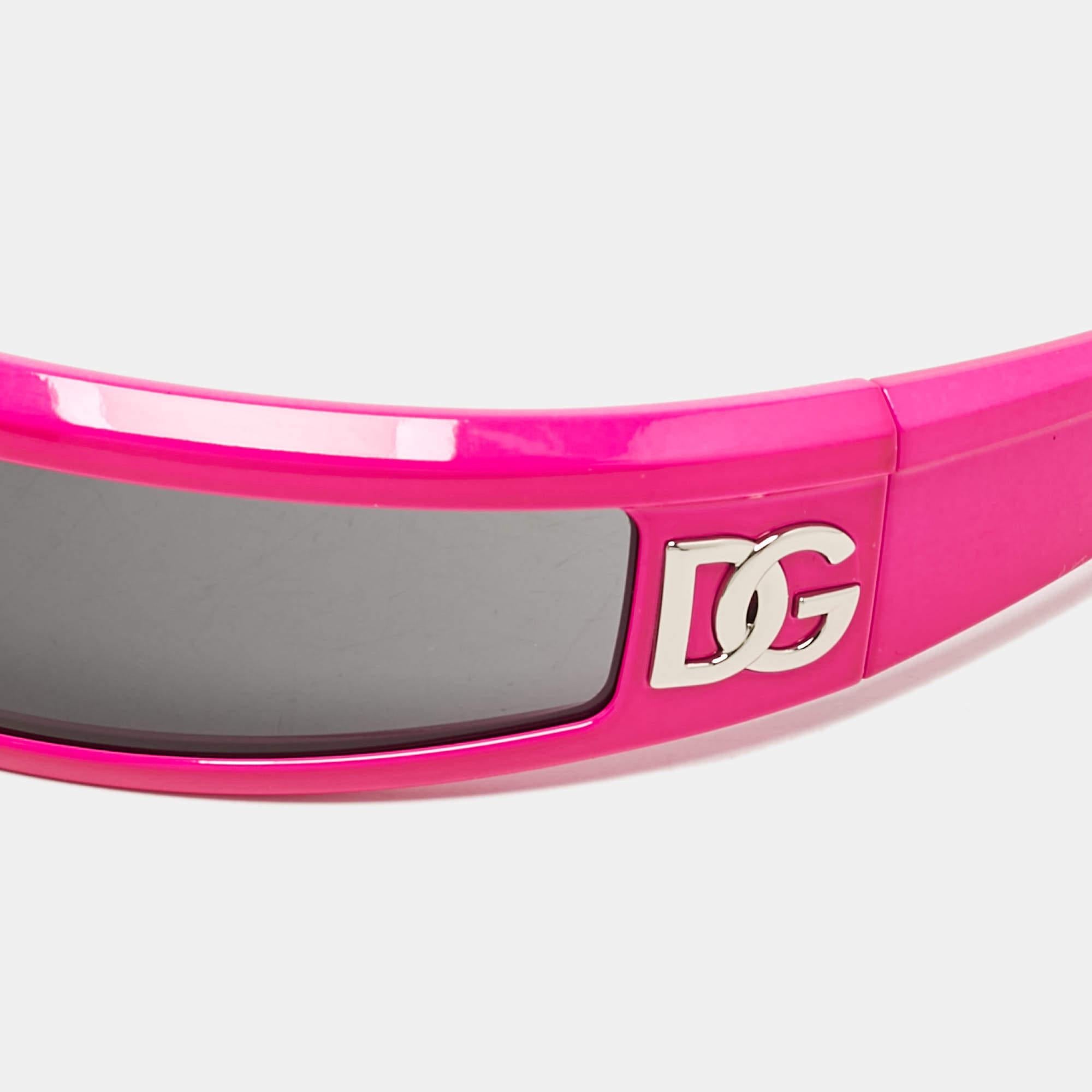 The Dolce and Gabbana sunglasses offer a bold  futuristic look with their sleek shield design. Featuring a striking pink and black color combination  these sunglasses provide full UV protection while ensuring a comfortable fit. The contemporary