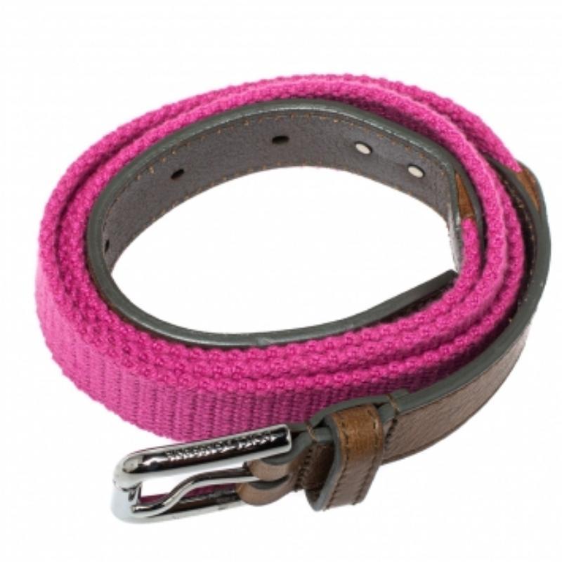 Add this stunning accessory from the house of Dolce & Gabbana to your collection. Featuring a pink canvas and brown leather body, this belt comes with a silver-tone buckle on the front. Style with a billowy dress to cinch the waistline for a chic