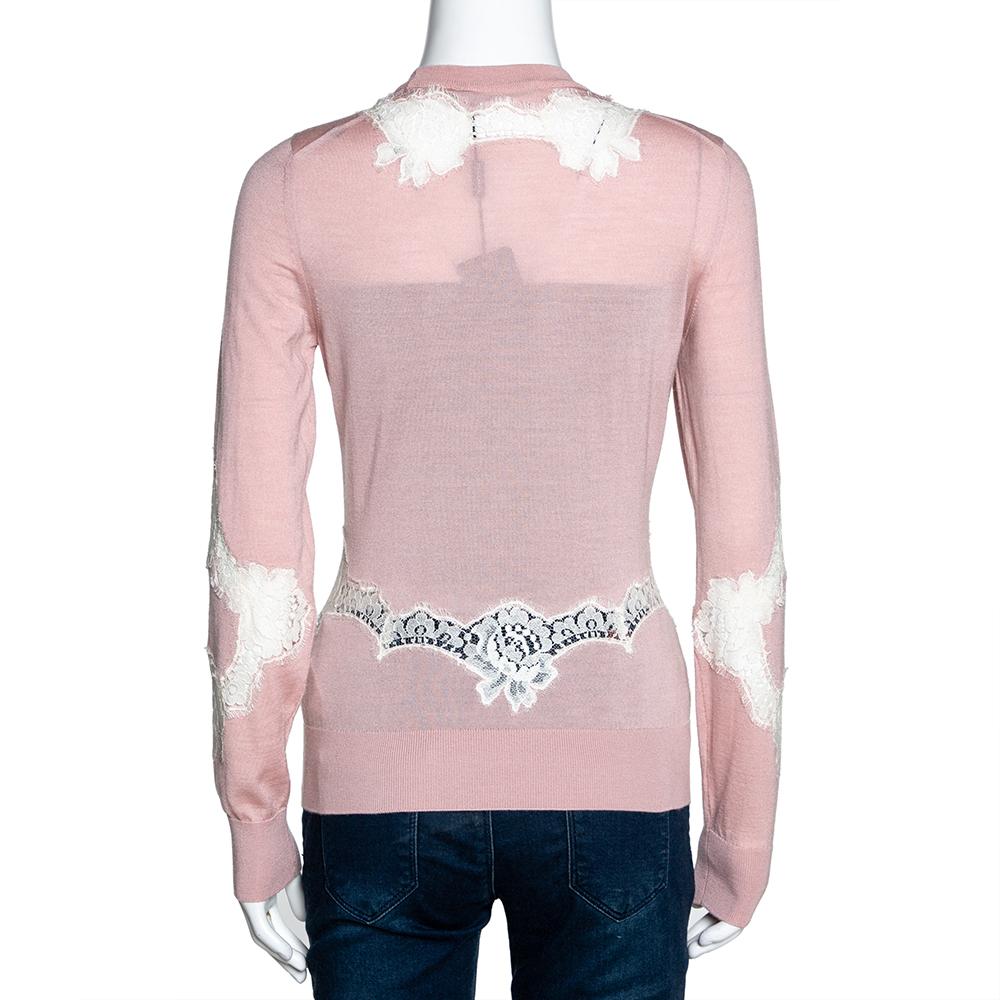 Elegance becomes you in this stylish and feminine sweater from Dolce & Gabbana. Crafted from a luxurious blend of cashmere, silk, and cotton, it carries a lovely shade of pink that is accented with intricate chantilly lace. The sweater is styled
