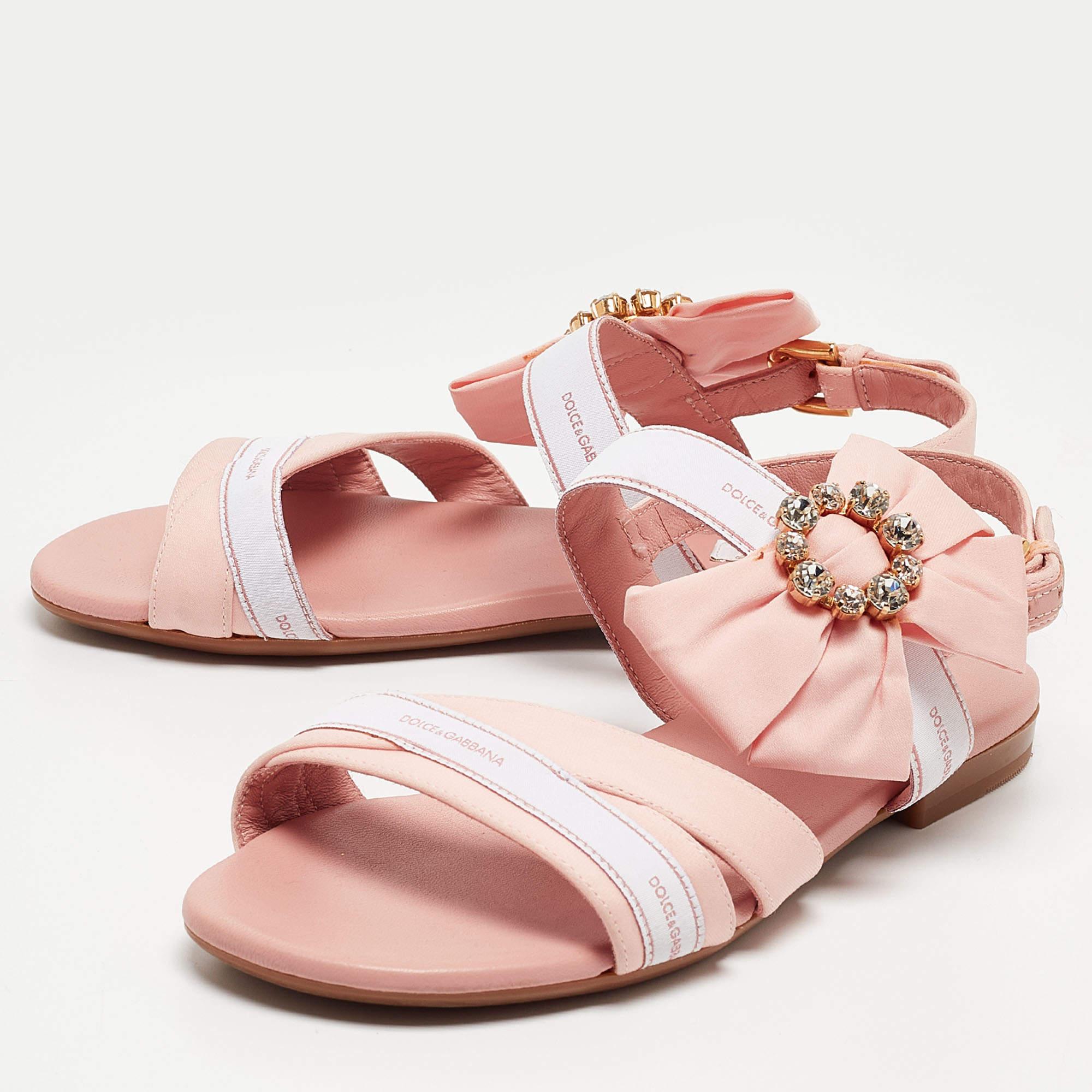 These stylish and playful sandals by Dolce and Gabbana are perfect for various occasions. Crafted from fabric they come in beautiful hues and are styled with open toes. They have a beautiful crystal embellishment buckle closure and gold tone