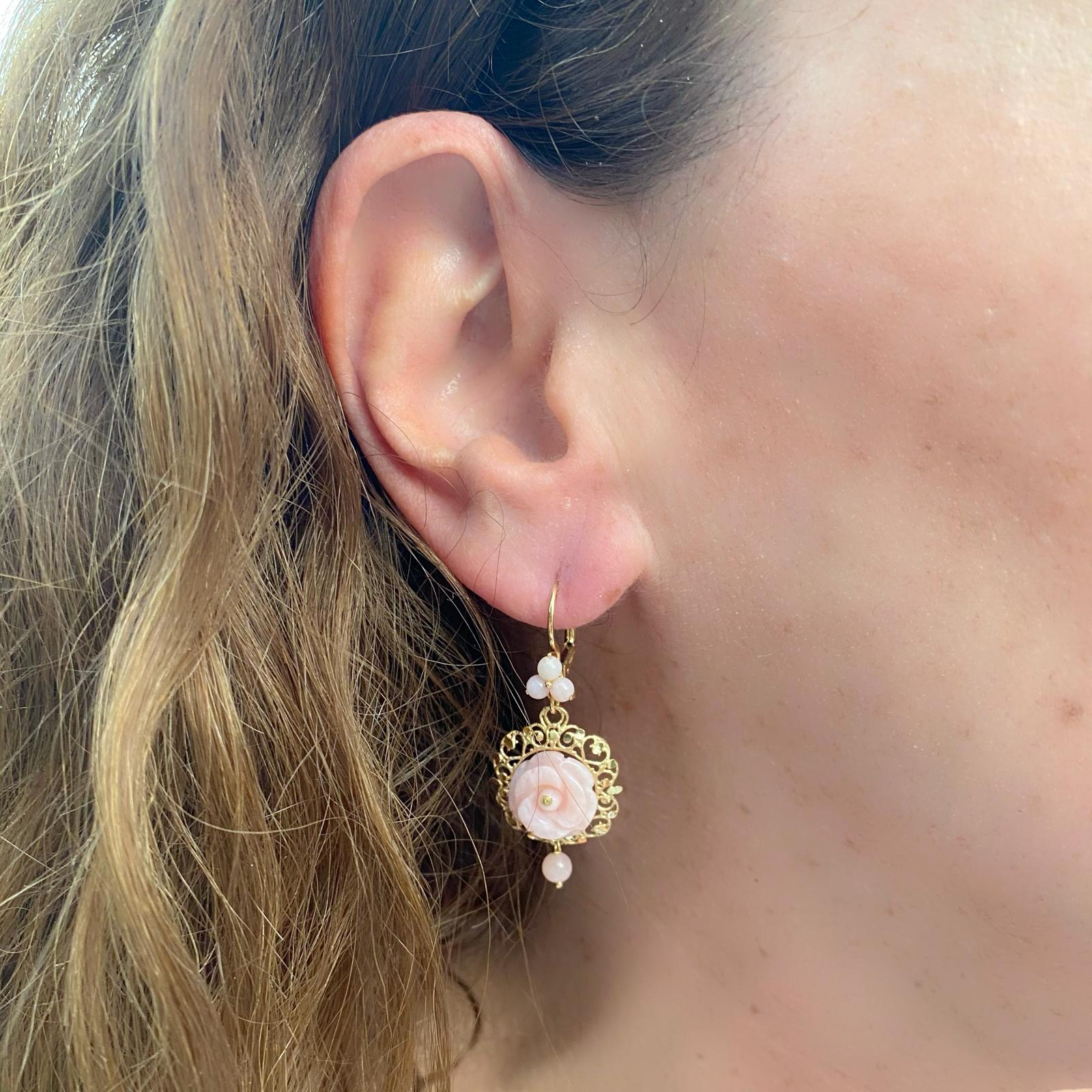 High fashion for every day! These 18k gold drop earrings by Dolce & Gabbana are designed with carved pink jade flowers in a filigree frame, and accented by pink jade beads and with lever-backs. The earrings weigh 6.3 grams and measure 1 1/2in. long.
