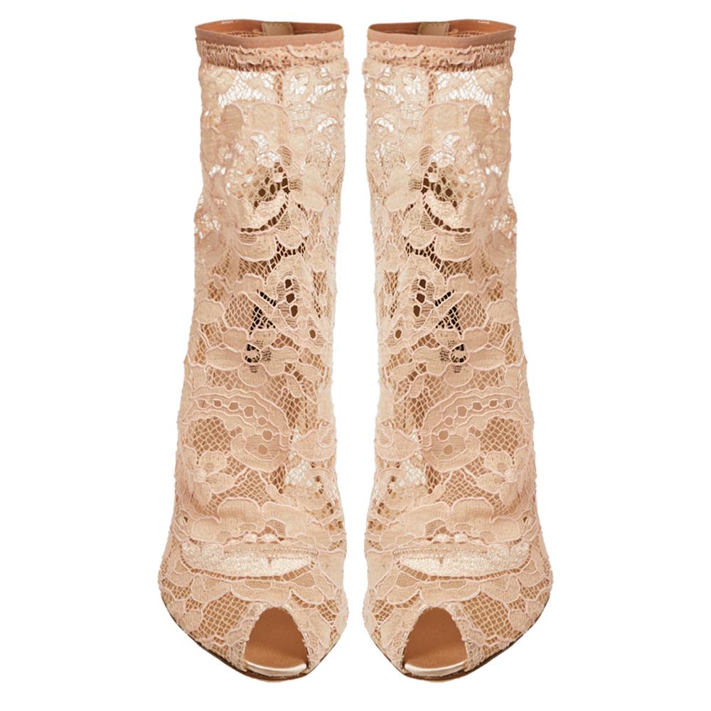 Style your ensemble with this pair of Dolce & Gabbana's peep-toe ankle boots. Crafted in dainty floral-patterned lace in a pink hue, they feature peep-toes and sock-like structure to create an unmatched look. The booties are accented with 10 cm