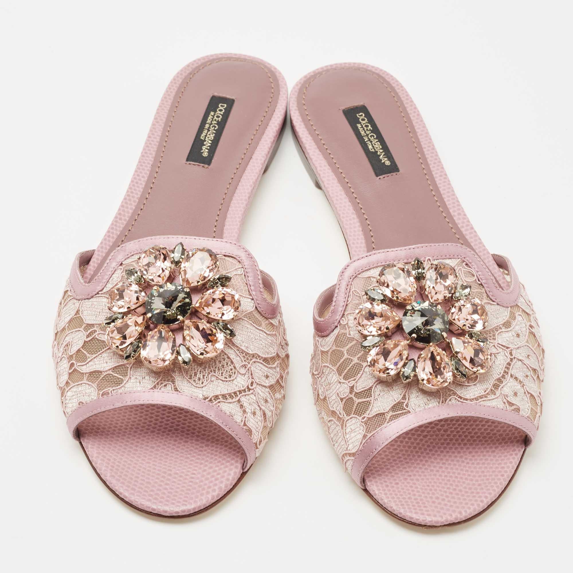 These Dolce & Gabbana slides have a lace upper and a leather base. What makes these slides so desirable is the breathtaking cluster of crystals on the vamps. This is definitely one pair that speaks beauty in a nonchalant way.

Includes: Original