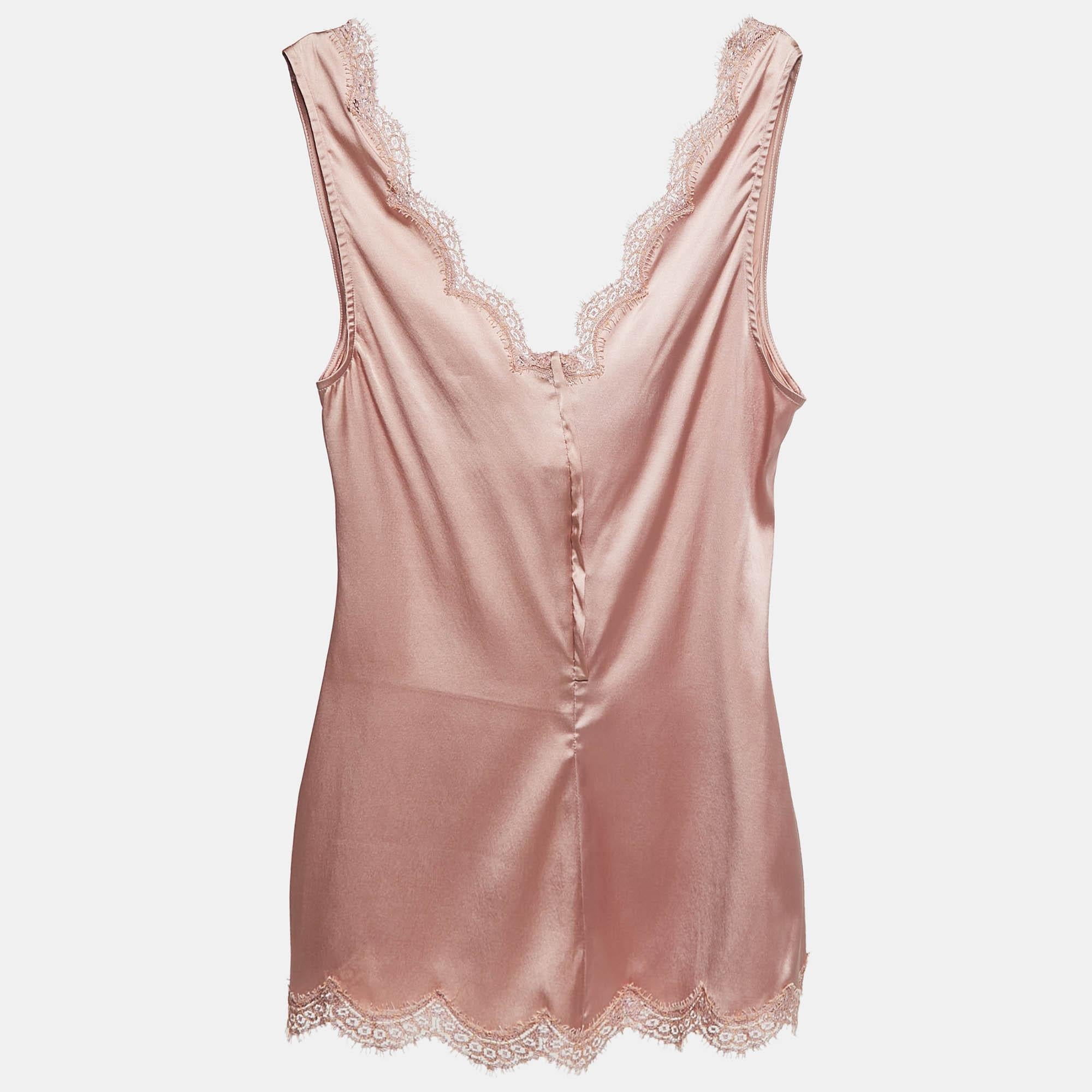 The Dolce and Gabbana camisole top offers a luxurious feel with its soft satin fabric and delicate lace detailing. The subtle pink hue adds a feminine touch  while the stretch fabric ensures comfort and a flattering fit. Perfect for layering or