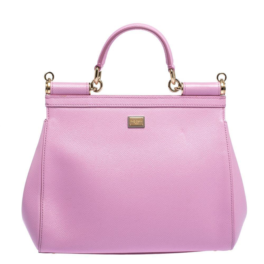 Look stylish and fabulous with this tasteful Dolce & Gabbana Miss Sicily bag. Featuring #dg family patch on the front, this delightful pink bag is smartly crafted from leather. The whimsical and playful design of the bag is sure to elevate your