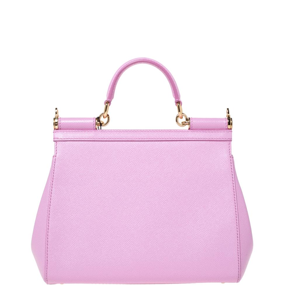 This gorgeous pink Miss Sicily bag from Dolce & Gabbana is a handbag coveted by women around the world. It has a well-structured leather exterior and flap that opens to a compartment with enough space to fit your essentials. The bag comes with