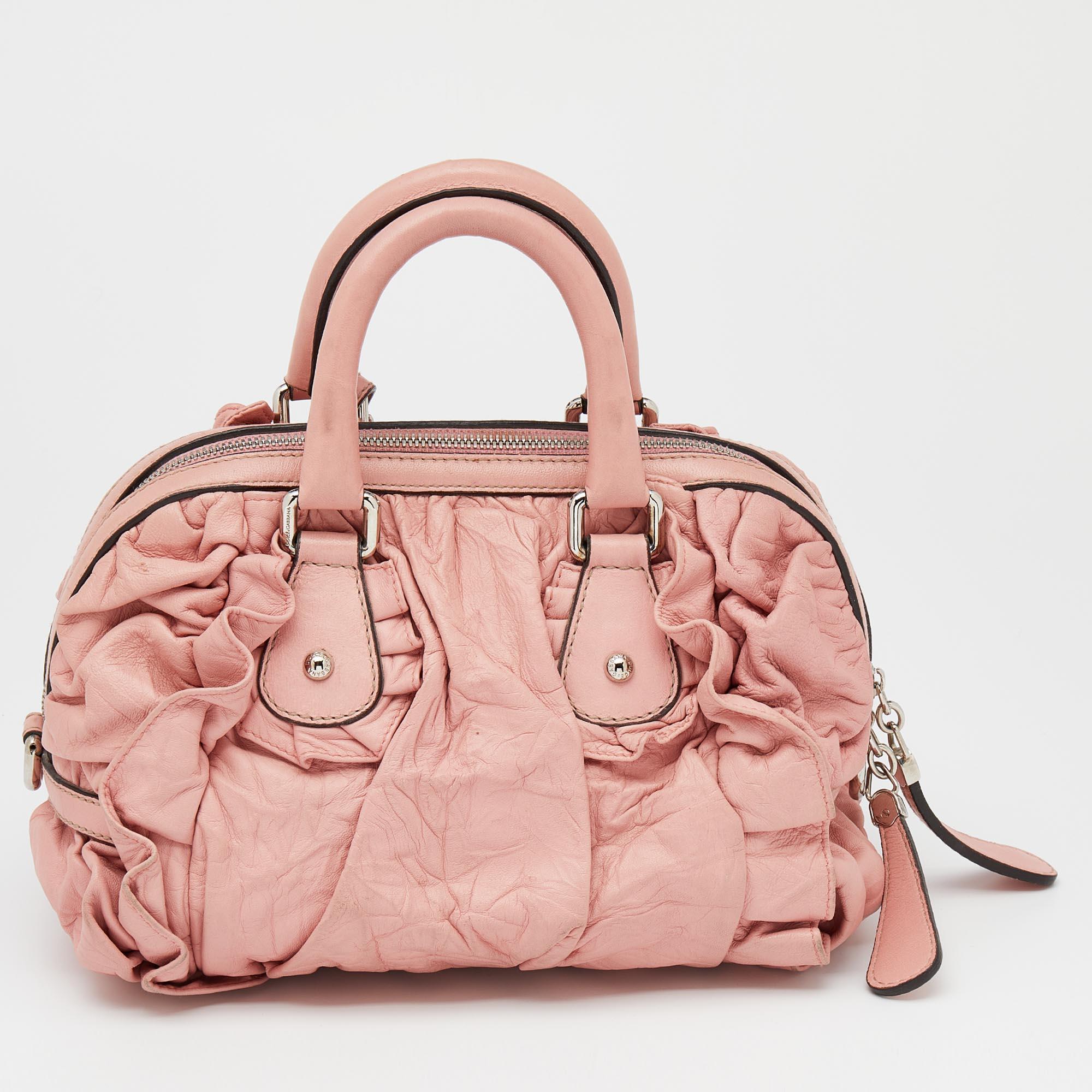 This Miss Rouche satchel from Dolce & Gabbana is designed to offer function and style at the same time. It is made of leather and decorated with ruching. Its compact shape is held by dual top handles.

