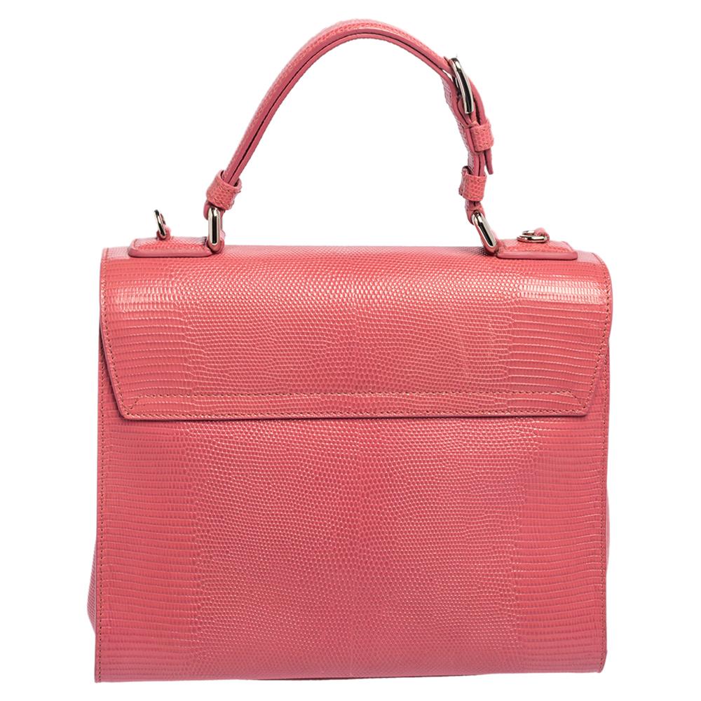 Well-structured and high on style, this Miss Monica bag from Dolce & Gabbana deserves to be yours! It has been crafted from lizard-embossed leather and styled with a top handle. It also comes with a silver-tone latch-lock flap that reveals insides