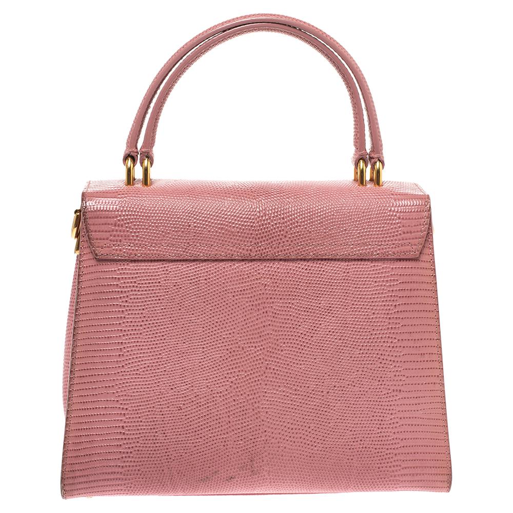 Dolce & Gabbana is all set to impress you with this bag. Crafted from lizard-embossed leather, it features top handles along with a detachable shoulder strap to keep you hands-free. This bag has a flap closure that reveals the well-sized fabric