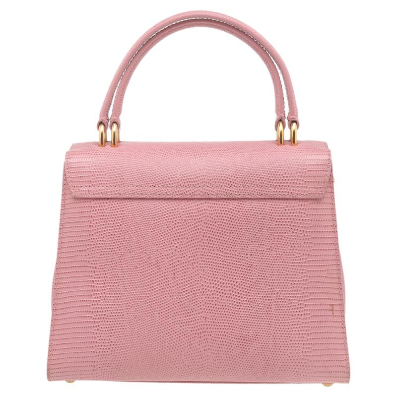 Dolce & Gabbana delights with this bag. Crafted from lizard-embossed leather, it features top handles along with a detachable shoulder strap to keep you hands-free. This bag has a flap closure that reveals the well-sized fabric interior. It is