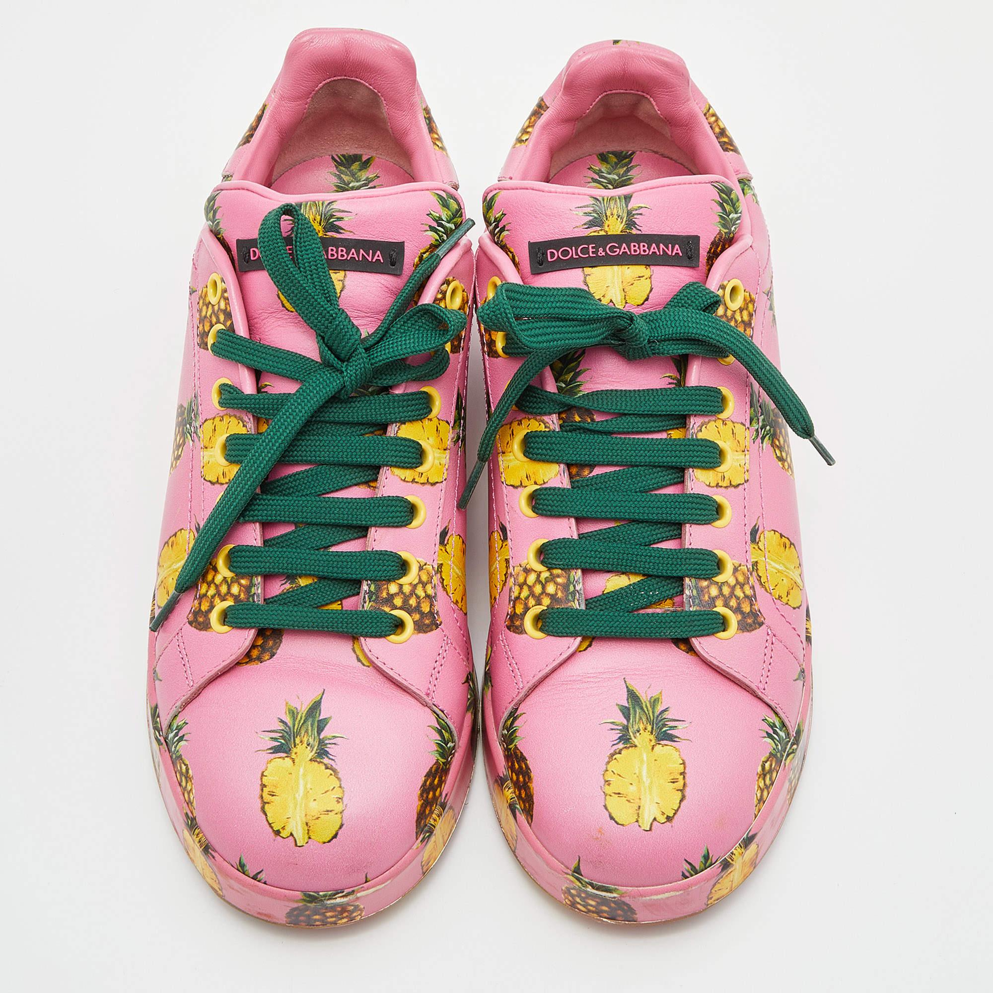 You can look bright as the sun by wearing these low styled sneakers from Dolce & Gabbana. It is made from pink leather and has a fine print of pineapples all over. This laced up pair of shoes carries the brand name on the tongues and counters. They