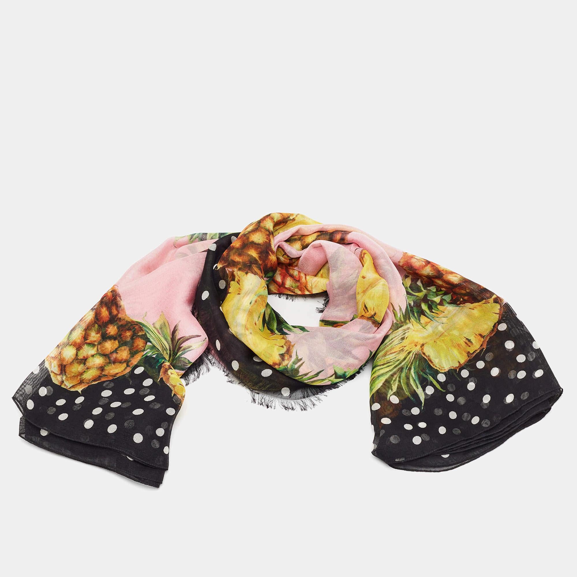 Add a playful touch to your wardrobe with this Dolce and Gabbana pink silk scarf featuring a vibrant pineapple print. Crafted from luxurious silk it offers a soft lightweight feel perfect for any season. Whether styled around the neck hair or