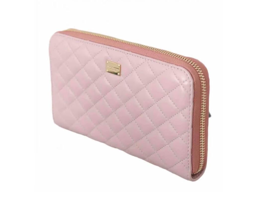 Stunning Dolce & Gabbana pale pink quilted soft lambskin wallet.
 
  Model: Continental Wallet Pouch
  Material: 100% leather
  Color: pink with gold metal details
  Beige interior lining
  Cardholder slots and coin pockets with zipper closure
 