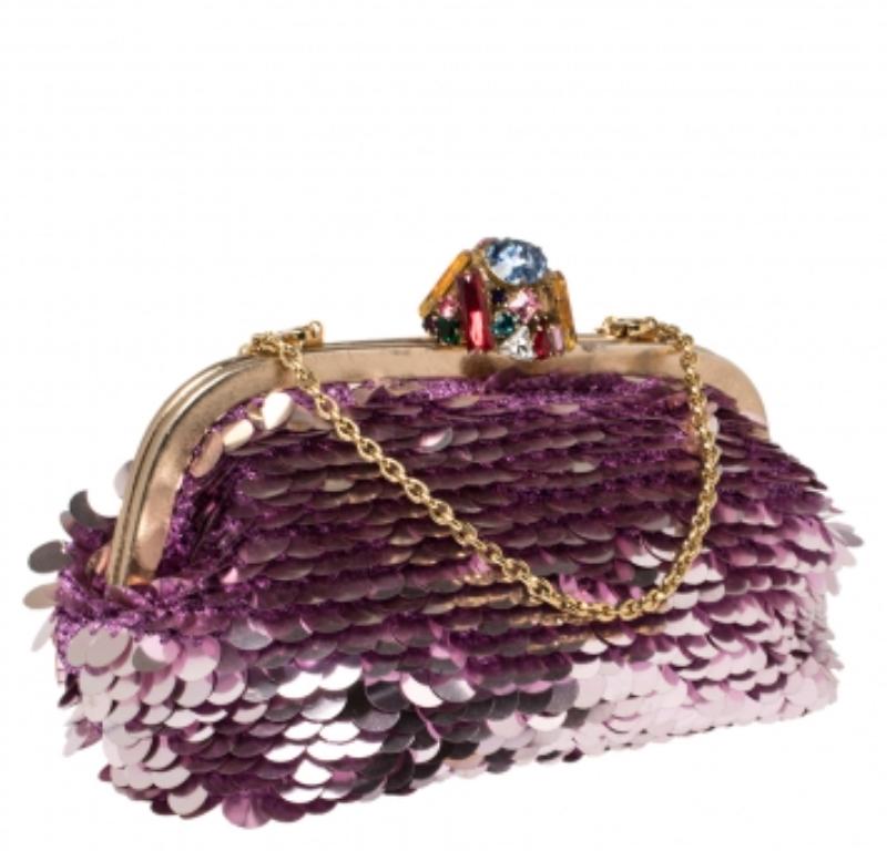 Dolce & Gabbana's glamorous attitude is seen in this clutch. The creation is covered with pink-hued sequins and a crystal-embellished closure at the top that opens to a fabric-lined interior. Carry it to the next party.