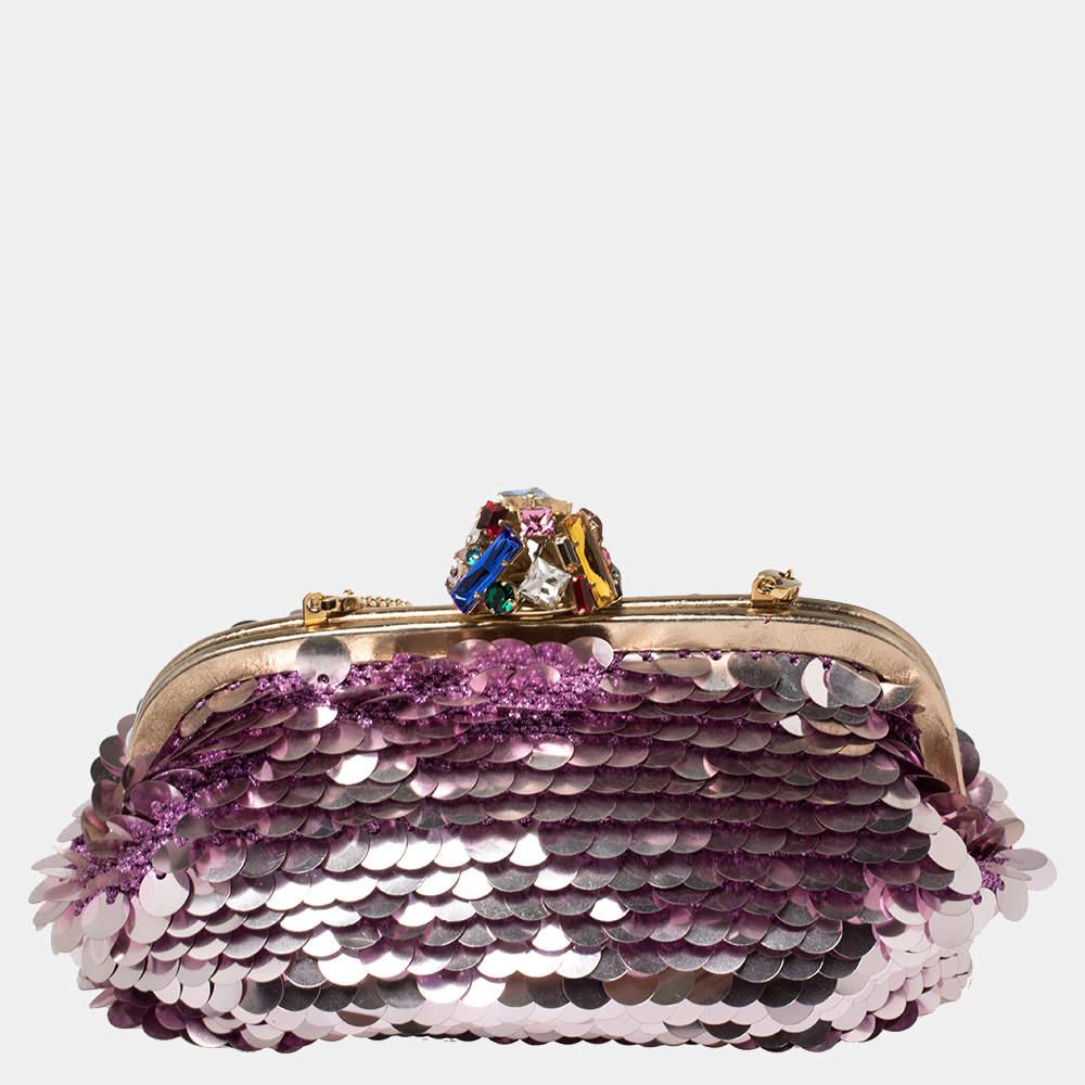 Dolce & Gabbana's glamorous attitude is seen in this clutch. The creation is covered with pink-hued sequins and a crystal-embellished closure at the top that opens to a fabric-lined interior. Carry it to the next party.

Includes: Authenticity Card,