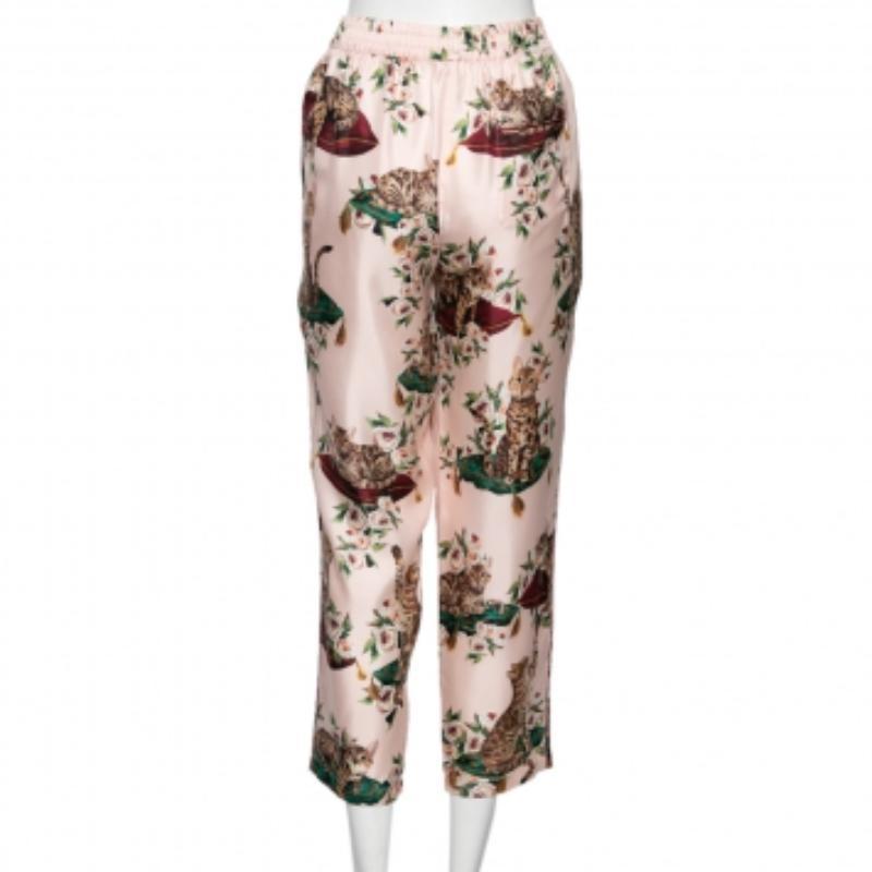 Feel supremely comfy dressed in these pajama pants from Dolce & Gabbana. The silk creation shows a pretty floral and cat print all over and comes with pockets. Pair the pink pants with slides for that chic casual look!