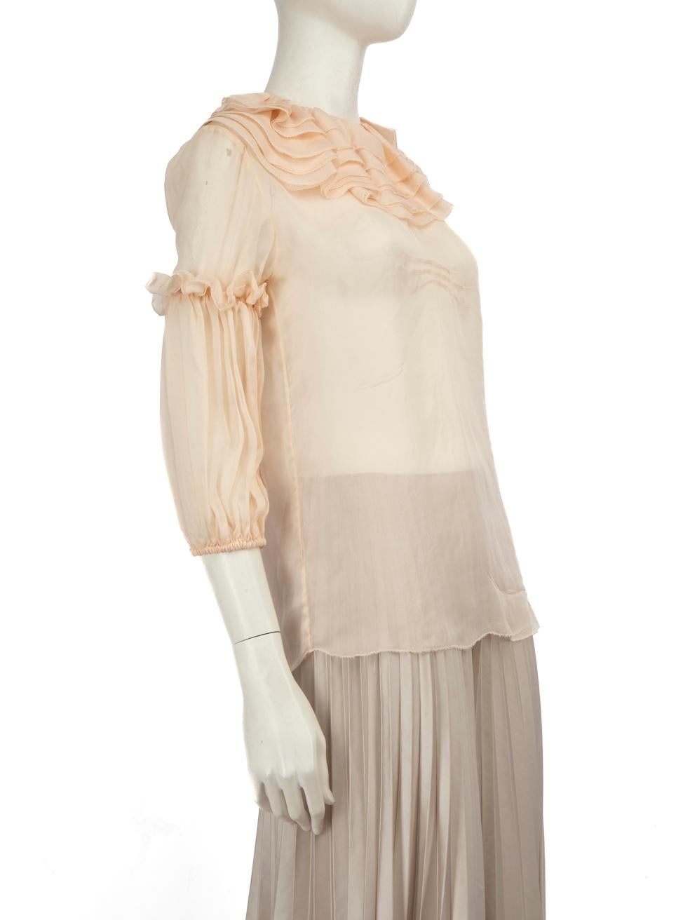 CONDITION is Good. General wear to the blouse is evident and the composition label has been removed. Moderate signs of wear to the fabric with pulls to the weave on both side seams, three on the front bodice, one at the top of the left sleeve and