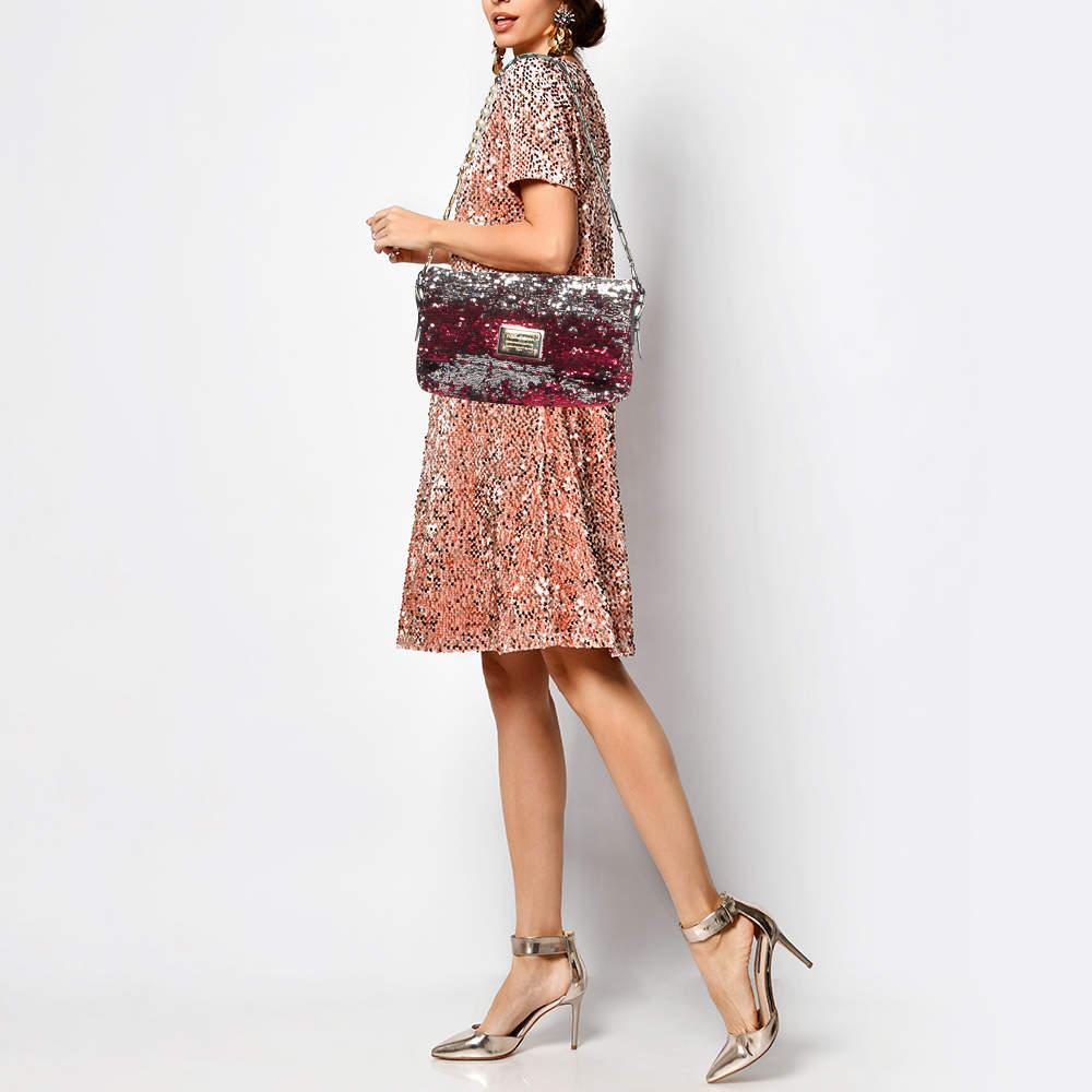 This elegant shoulder bag from Dolce and Gabbana is perfect for your next outing to town. It is made of high quality leather and can match a day or evening outfit. It has a long strap and a lined interior secured by a flap.