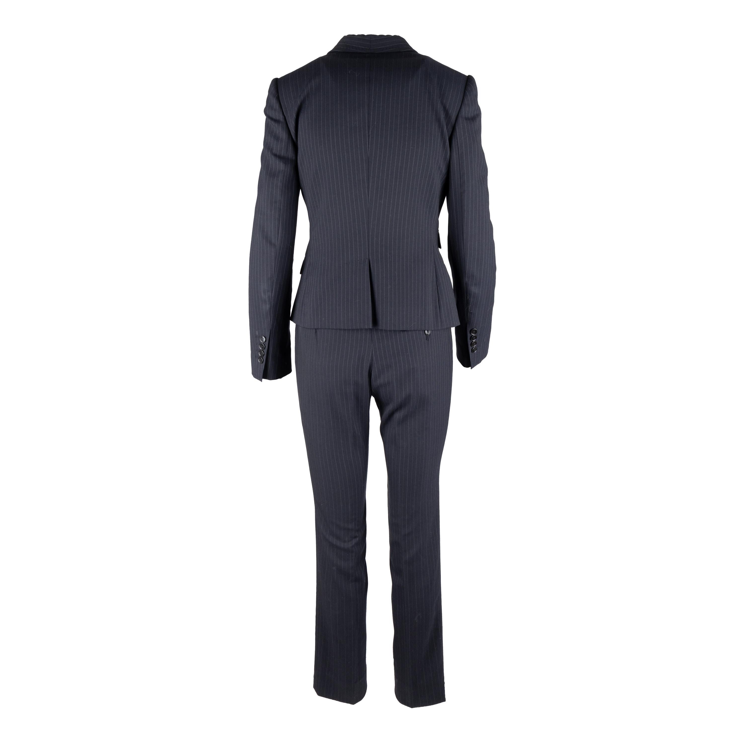 This Dolce & Gabbana pinstripe suit exudes chic sophistication with its tailored look. Crafted from a virgin wool blend, the suit is complete with a vest, jacket, and trousers, all featuring tonal pinstripes. Lean cut lapels and pocket flaps define