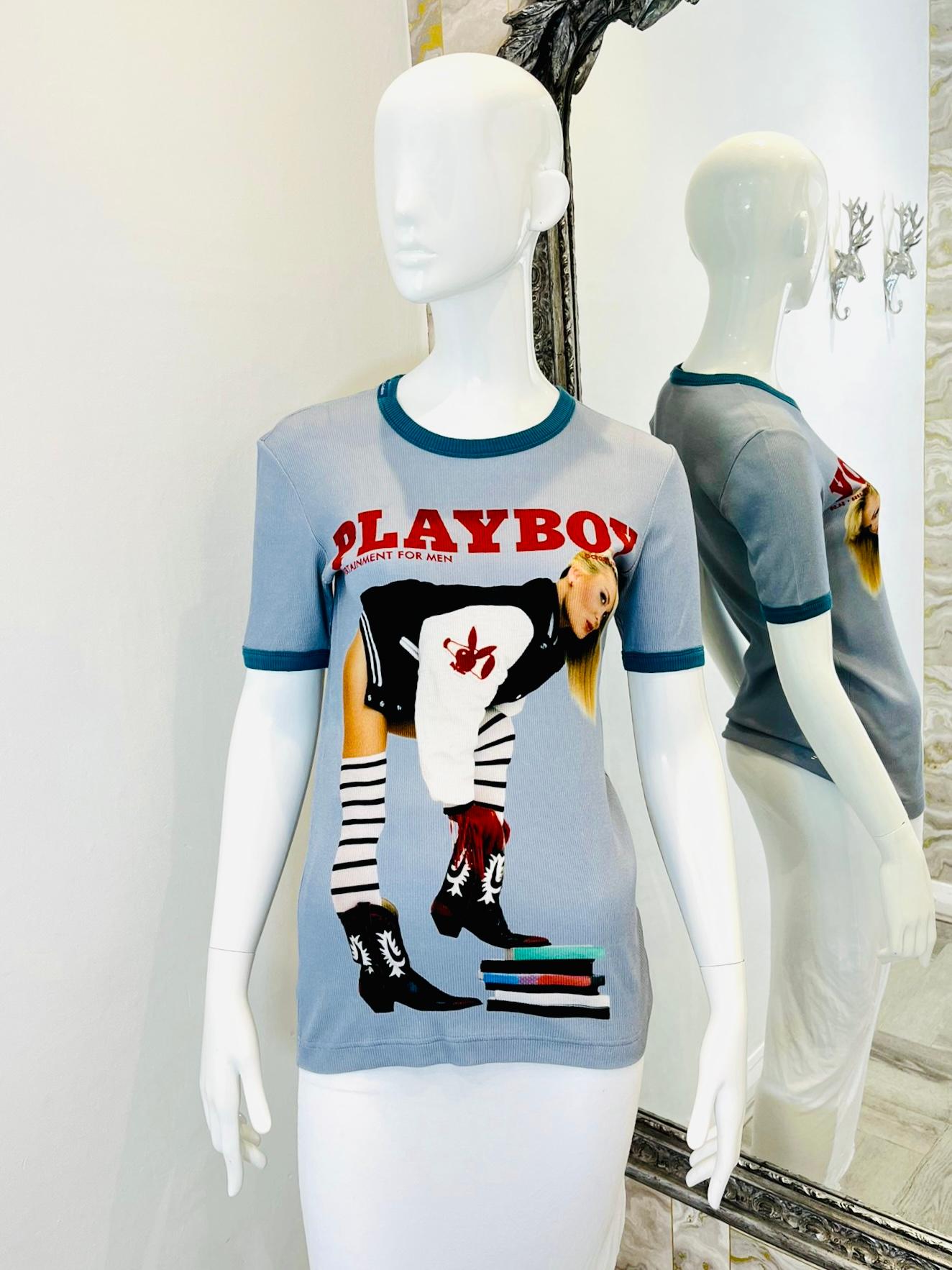 Dolce & Gabbana 'Playboy' T-Shirt - Unisex

Grey cotton ribbed top with green contrasting trim to the neckline and cuffs.

Printed 'Playboy' image to the front. Logo to neckline.

Size - 48IT

Condition - Very Good

Composition - Cotton (Label