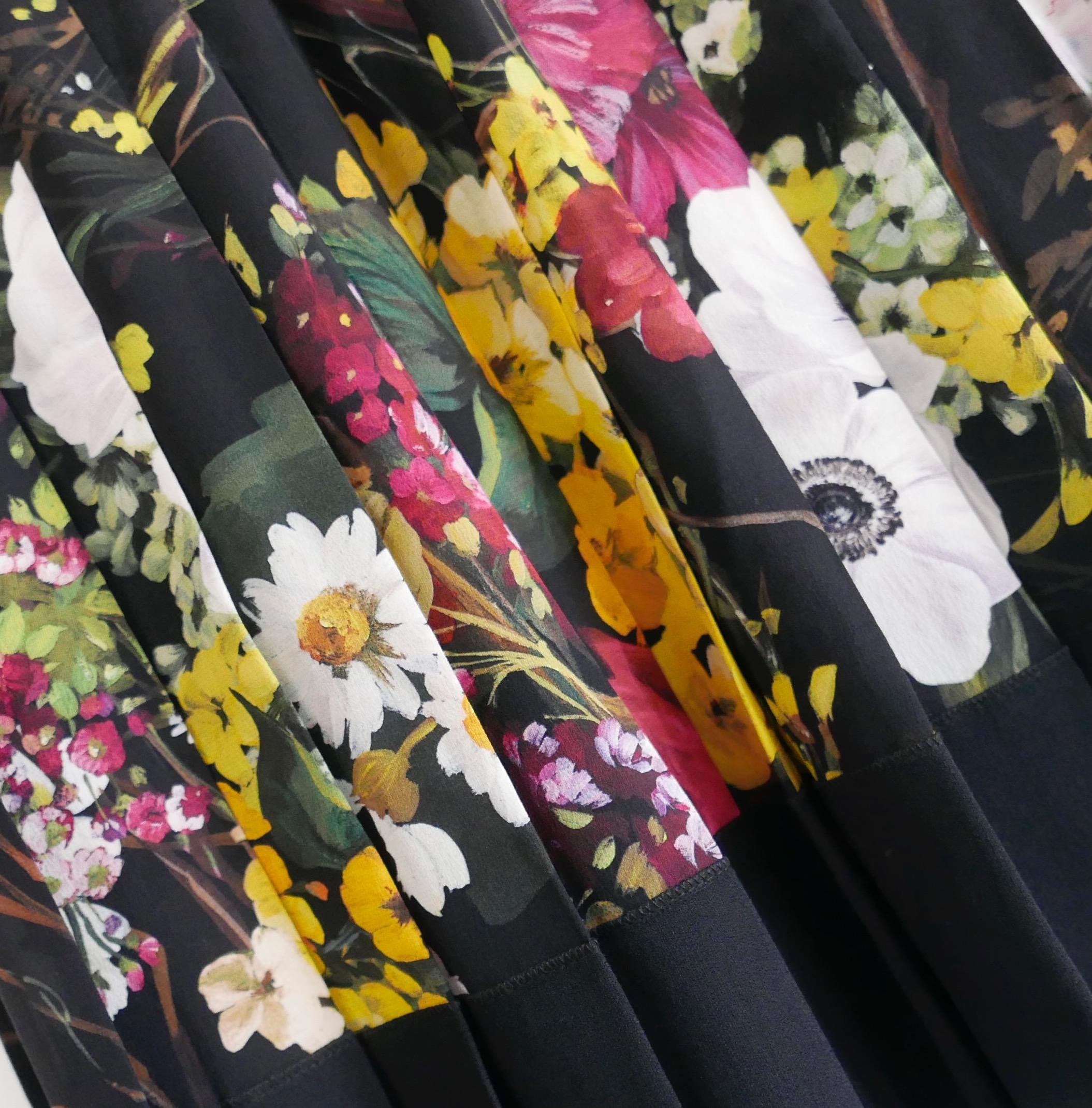 Gorgeous Dolce & Gabbana pleated floral print short skirt. Bought for £925 and unworn. Made from black backed mixed floral print silk mix with plain black hem and waistband. It has a flared cut with wide pleats throughout and zip back. Size IT40/UK8
