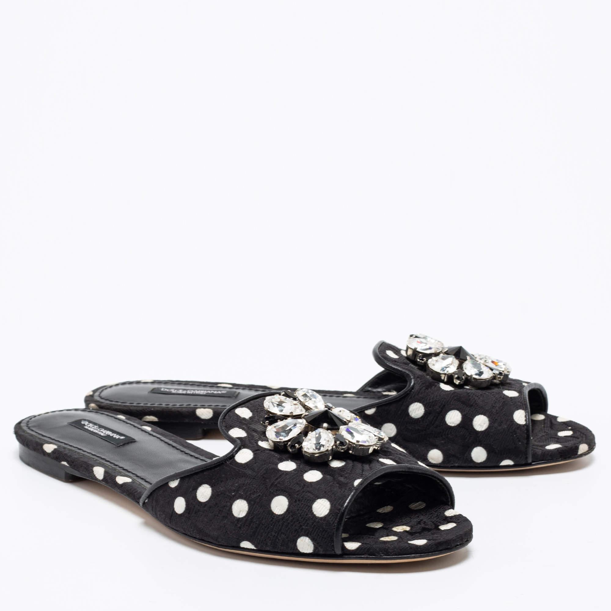 This beautiful pair of flats by Dolce & Gabbana will elevate any outfit. Designed to deliver glamour and style, these flats are crafted from black & white polka dot fabric. These slides feature an open-toe silhouette, uppers adorned with crystal