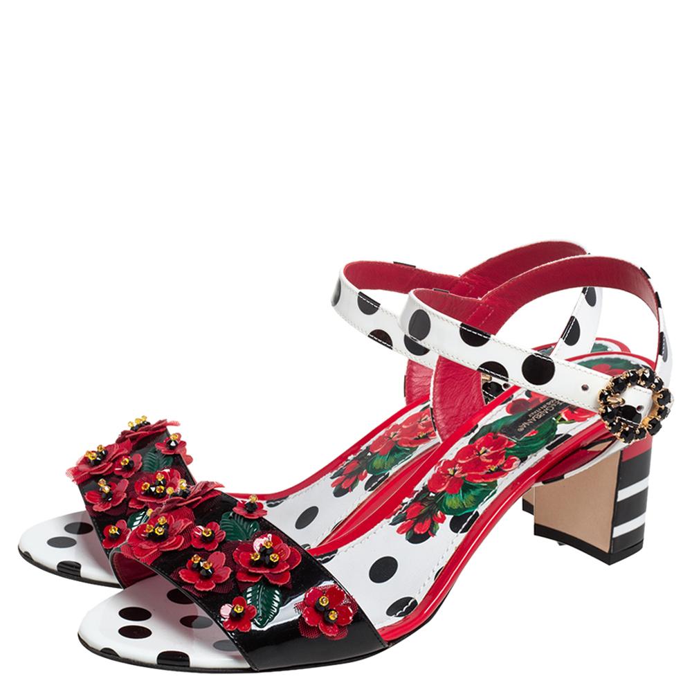 Coming from the house of Dolce and Gabbana, these sandals feature frontal straps decorated with a crystal-embellished floral accent that makes it perfect for the woman who likes comfort with a hint of shine. Made from polka dot accented patent