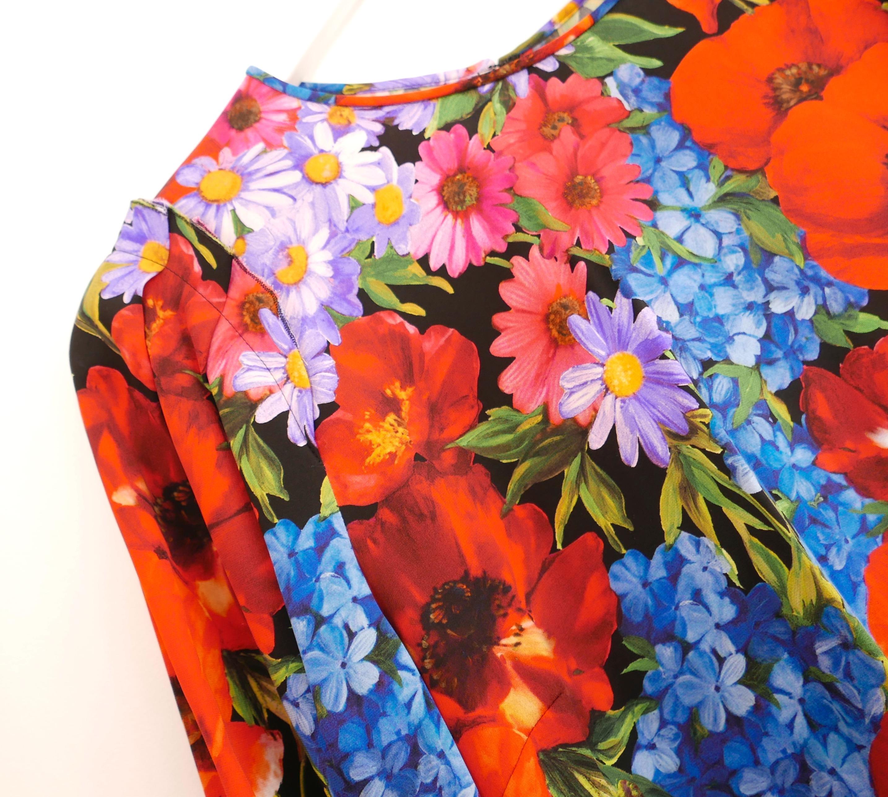 Stunning Dolce & Gabbana poppy print top. bought for £950 and unworn. Made from lightweight silk and elastane with a brightly coloured poppy and mixed floral print on a black background. It has a super fluid, relaxed cut with piped round neck, long