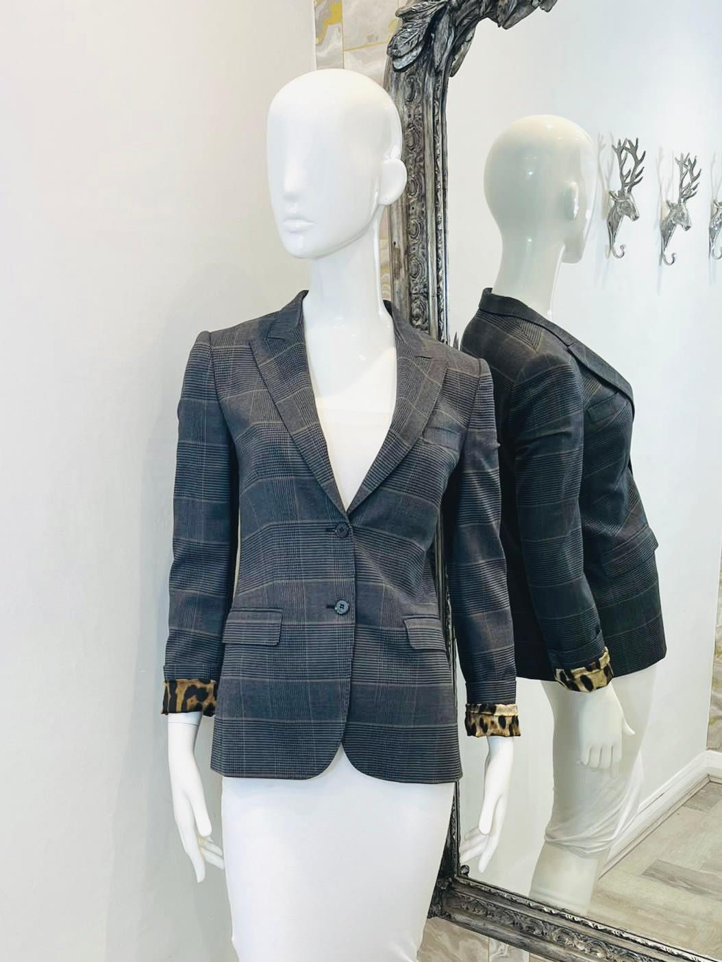 Dolce & Gabbana Prince Of Wales Check Wool Blazer

Grey check jacket in a English heritage style with button up closure and leopard print satin lining. Can be worn with cuffs showing print if desired. Flap pockets. Buttoned cuffs.

Size -