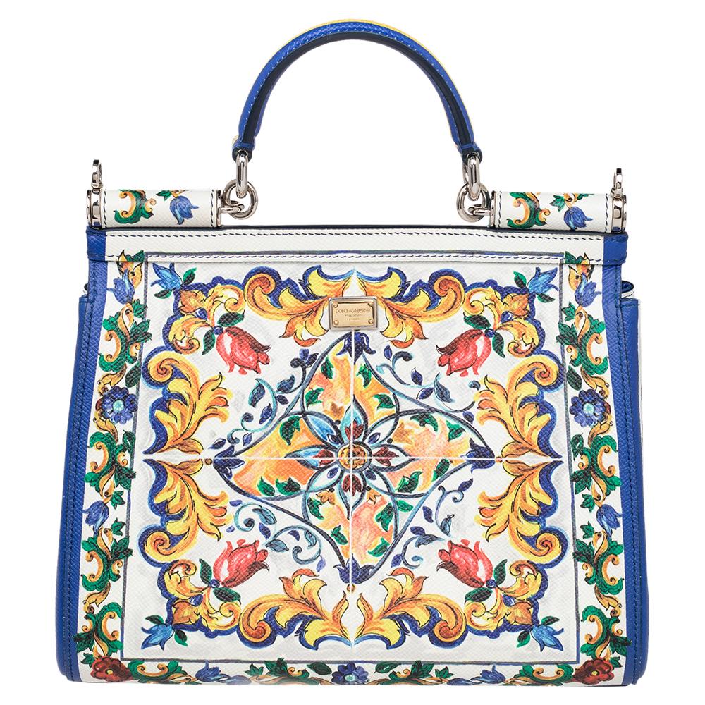 This Sicily bag from Dolce & Gabbana is a handbag coveted by women around the world. The multicolored printed leather bag has a flap that opens to a compartment with fabric lining and enough space to fit your essentials. It comes with silver-tone