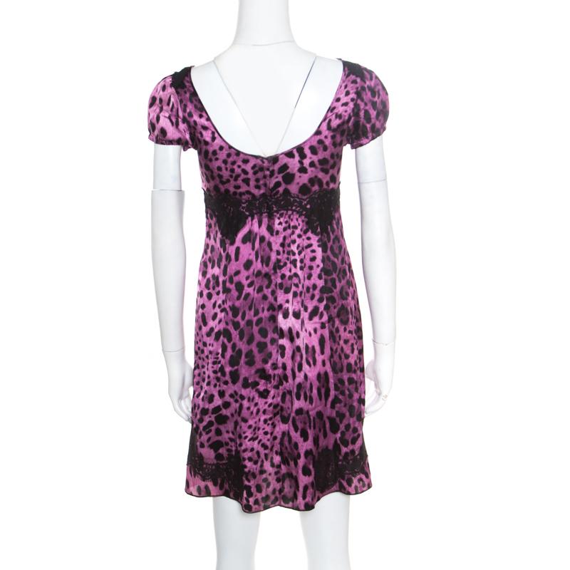 This Baby Doll dress from Dolce and Gabbana is so pretty, you'll love wearing it for your fashionable outings! The purple and black creation is made of a silk and cotton blend and features an animal print all over it. It flaunts a lace insert
