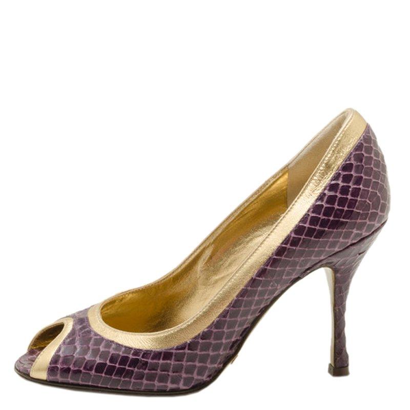 These gorgeous snake skin shoes from Dolce and Gabbana are perfect for a night out. A beautiful peep toe, with deep purple leather is finished with contrasting glossy gold trim. A 9cm heel is wearable while still elongating your legs. Perfect with a