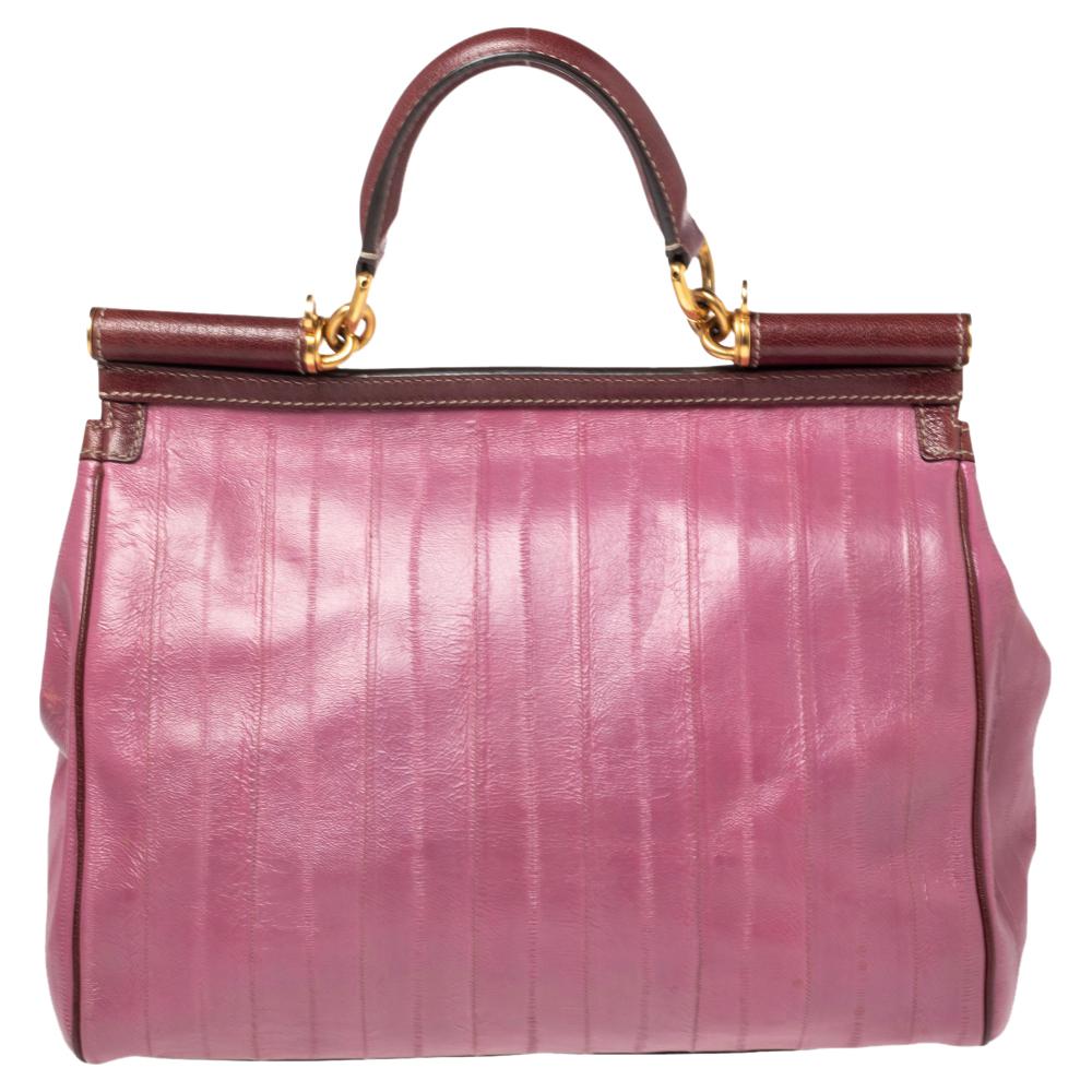 This gorgeous purple Miss Sicily bag from Dolce & Gabbana is a handbag coveted by women around the world. It has a lovely eel leather exterior and a flap that opens to a compartment with fabric lining and enough space to fit your essentials. The bag