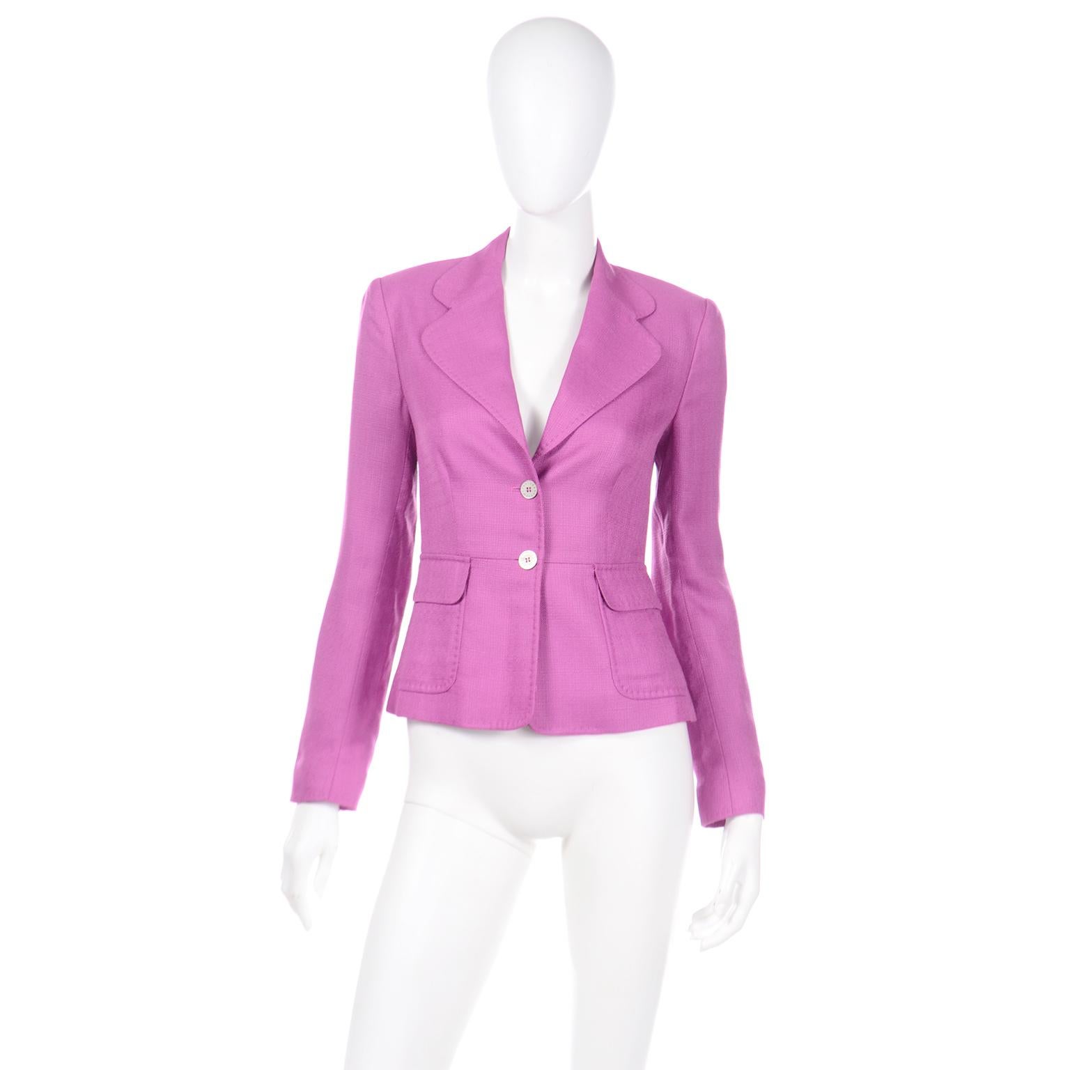 This fabulous Dolce & Gabbana blazer style jacket is in a pretty textured purple viscose. The jacket has front patch pockets, really unique topstitching, 2 branded front buttons, and it is fully lined. Both fabric and metal hang tag label are found.