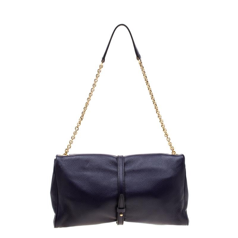 Add a touch of purple to your attire with this attractive leather bag. It has a fabric-lined interior, a chain handle with leather rest, and the logo plaque on the front. This beauty from Dolce & Gabbana is both durable and